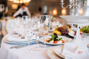 wedding table decorated with flowers and serving in the restaurant. Wrdding restaurant