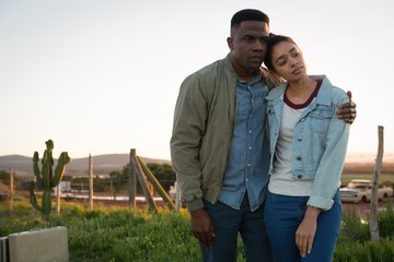 Couple standing together at countryside 