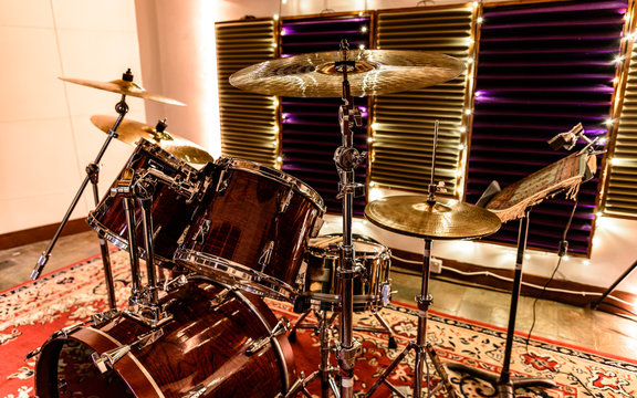 Drum kit setup in the recording studio with sound proofing and fairly lights