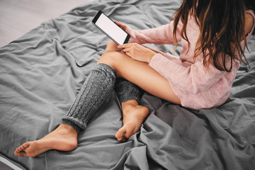 Girl sitting on bed in the morning