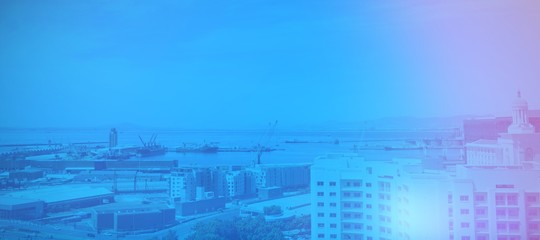 Buildings by sea against sky