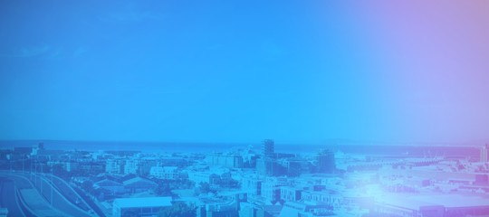 Fototapeta premium Cityscape by sea against blue sky