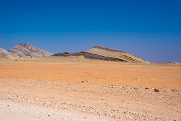 Naklejka na ściany i meble Road trip in the Namib desert, Namib Naukluft National Park, travel destination in Namibia. Travel adventures in Africa.