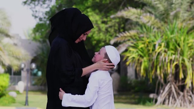 Arabic mother and son together outdoors.