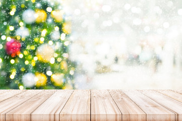 Naklejka na ściany i meble Christmas and New year theme background. Wooden table top with blur Christmas tree and winter background. Can be used product display.