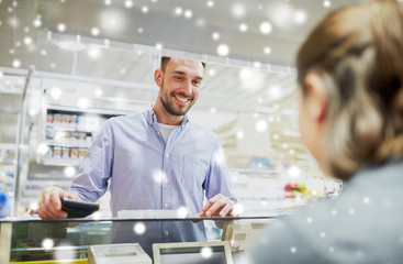 happy man with wallet at store cash register