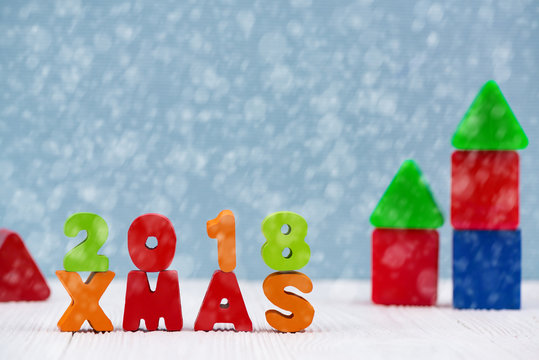 Xmas 2018 colorful wooden text on white wooden desk with Christmas decorations, Merry Christmas and happy new year concept.