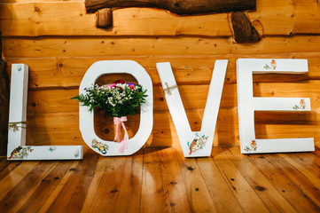 Wooden decorations. Wedding bouquet. Festive inspiration. Concepts and ideas. Bridal day. Orange vintage color rural room. Mixed flowers. Floral mood.