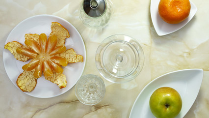 Still life with peeled mandarin and apple