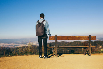 looking traveler to the mountains with a backpack