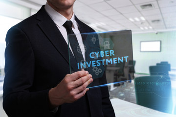 Business, Technology, Internet and network concept. Young businessman working on a virtual screen of the future and sees the inscription: Cyber investment