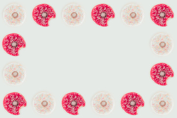 top view of frame made of pink and white glazed doughnuts isolated on white