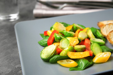 Plate of salad with Brussels sprouts on table