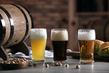 Glasses with different sorts of beer on table in sport bar