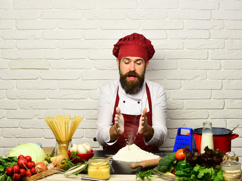 Chef prepares meal. Cooking process concept. Man with beard