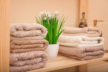 Clean towels on shelf in bathroom