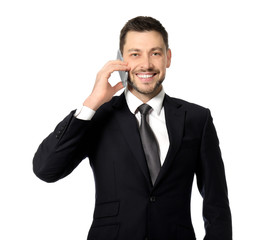 Attractive businessman talking on phone against white background