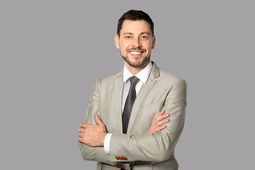 Attractive man in formal wear on grey background