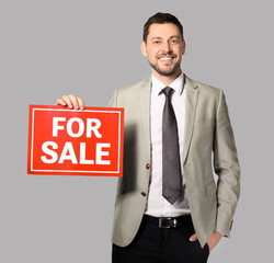 Attractive real estate agent holding 