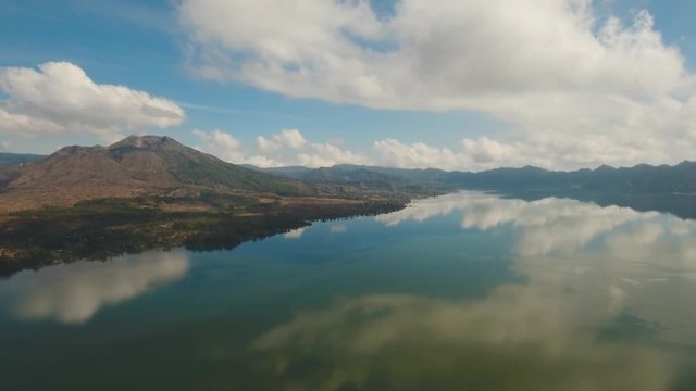 Aerial view Mountains, volcanoes, crater lake Batur, Bali, Indonesia. Mountain landscape with volcanoes, lake, sky and clouds. 4K video. Travel concept Aerial footage