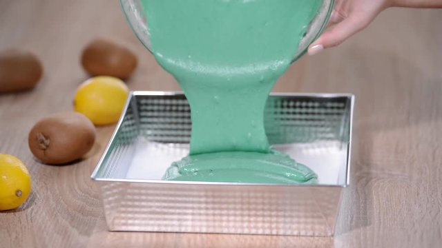 pouring batter into baking pan greased with butter