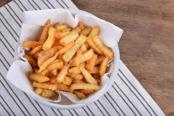 plate of french fries on wooden table