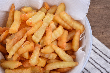 plate of french fries on wooden table