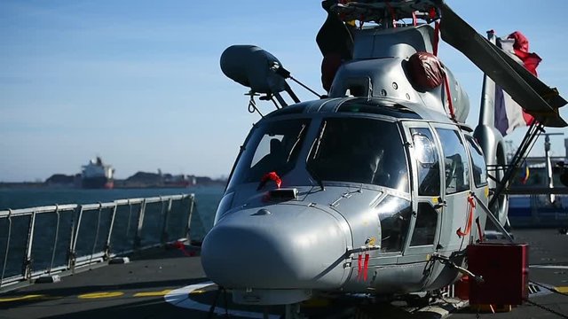 Helicopter parked on a platform of a war frigate 