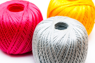 Three balls of yarn on white background.