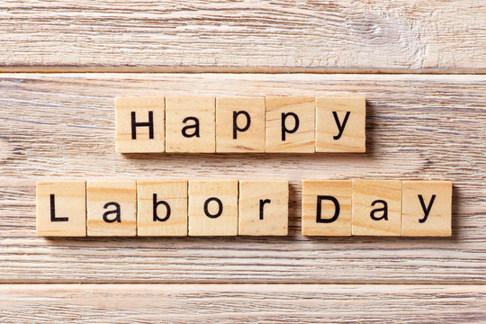 Happy Labor Day word written on wood block. Happy Labor Day text on table, concept