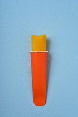 orange popsicle on a blue background