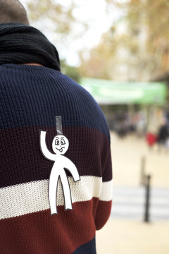 young man with a paper man attached to his back