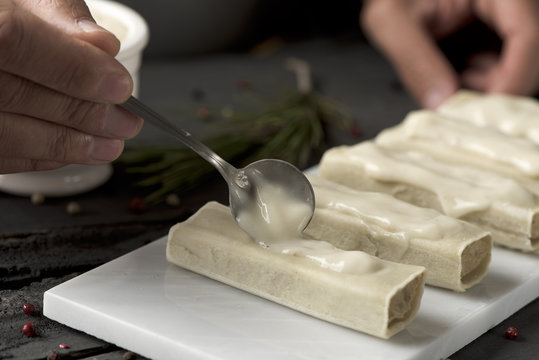 man preparing meat stuffed cannelloni