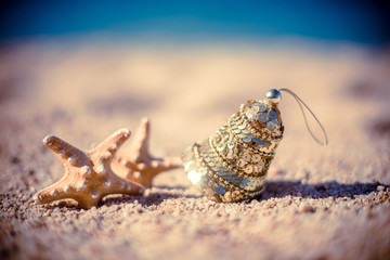 New Year's toy and starfish on the beach 