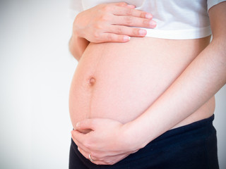 pregnant woman holds her hands on her belly.maternity concept.Belly of pregnant woman with hands.