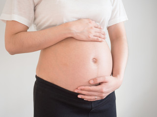 pregnant woman holds her hands on her belly.maternity concept.Belly of pregnant woman with hands.