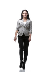 In full growth. The modern young woman confidently goes forward.