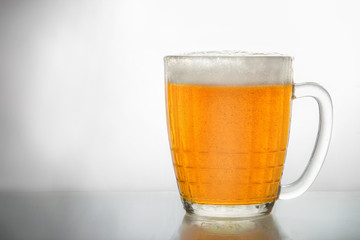 Frosty glass of light beer set isolated on a white background