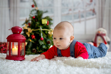 Fototapeta na wymiar Portrait of newborn baby in Santa clothes and christmas hat