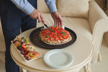 Tart with strawberries and whipped cream decorated with mint leaves. Top view