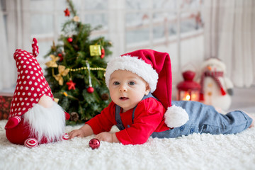 Portrait of newborn baby in Santa clothes and christmas hat
