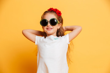 Little cute smiling girl wearing sunglasses looking camera.