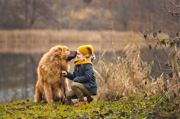 The walk of a child with a big dog on the lake 9812.