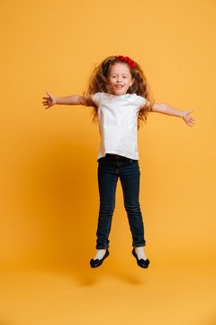 Cheerful little girl child jumping