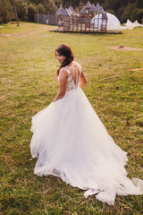 The beautiful bride walking along grass