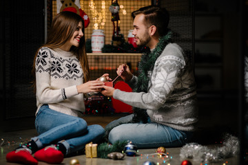Couple in love playing with Christmas home decorations