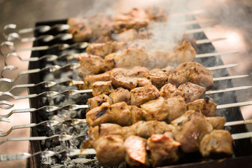 Marinated shashlik preparing on a barbecue grill over charcoal. Shashlik or Shish kebab popular in Eastern Europe. Shashlyk (skewered meat) was originally made of lamb. Roast Beef Kebabs On BBQ Grill.