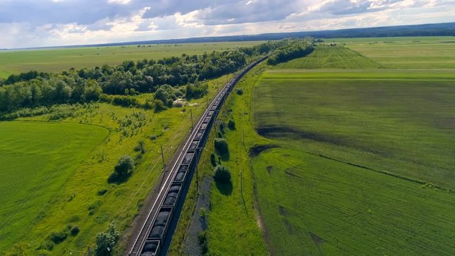 Aerial shot of a big cargo train transporting coal.