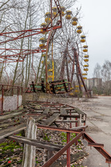 Fototapeta na wymiar Attraction in amusement park in overgrown ghost city Pripyat.