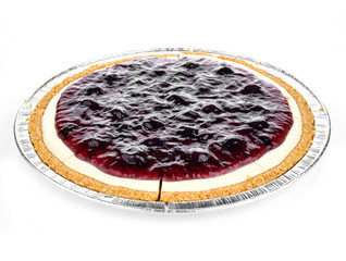 round cheesecake with blueberries top view on a white background